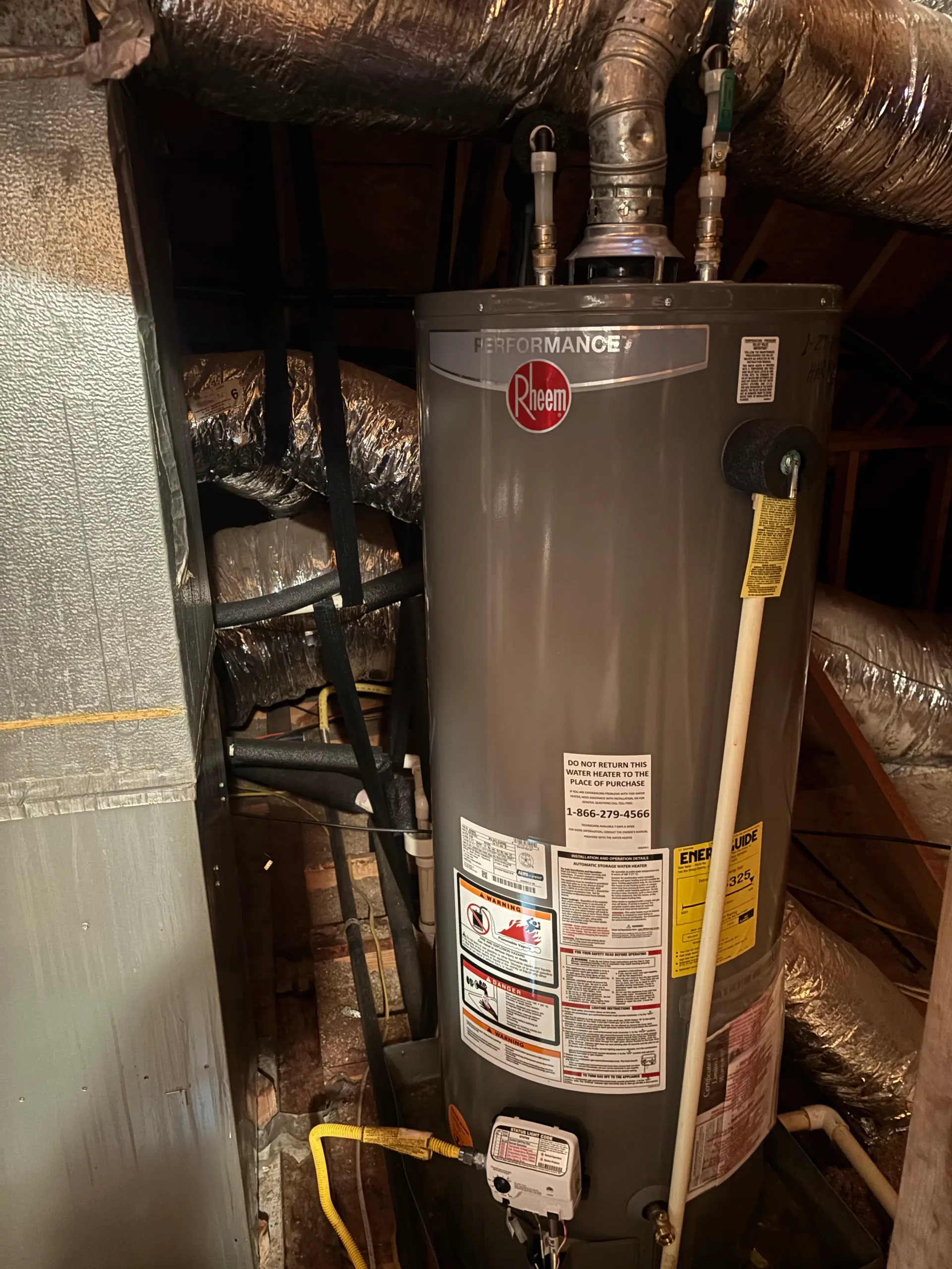 Rheem Performance gas water heater installed in an attic with insulated ductwork