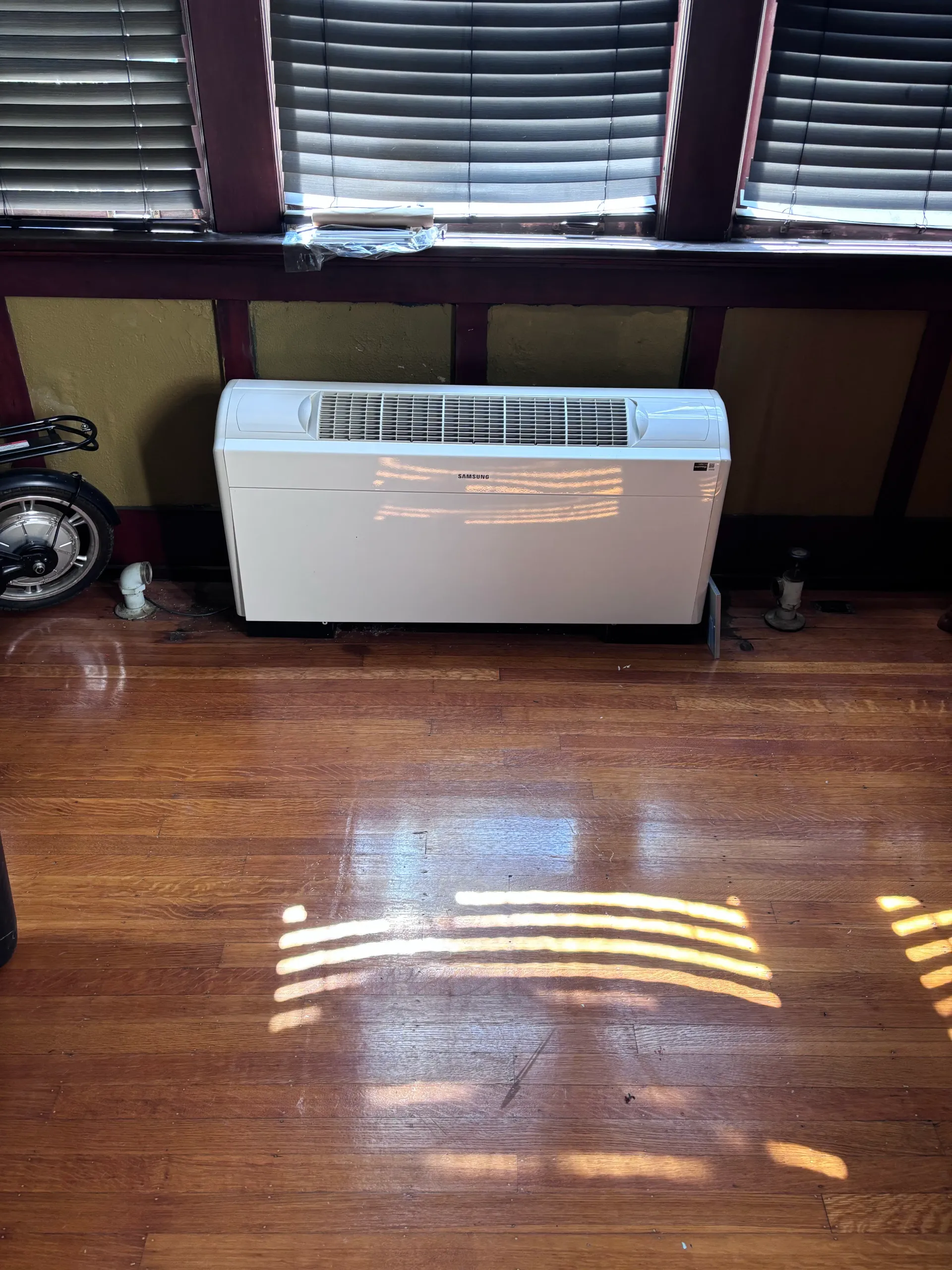 Samsung ductless floor-console indoor unit installed against a wall