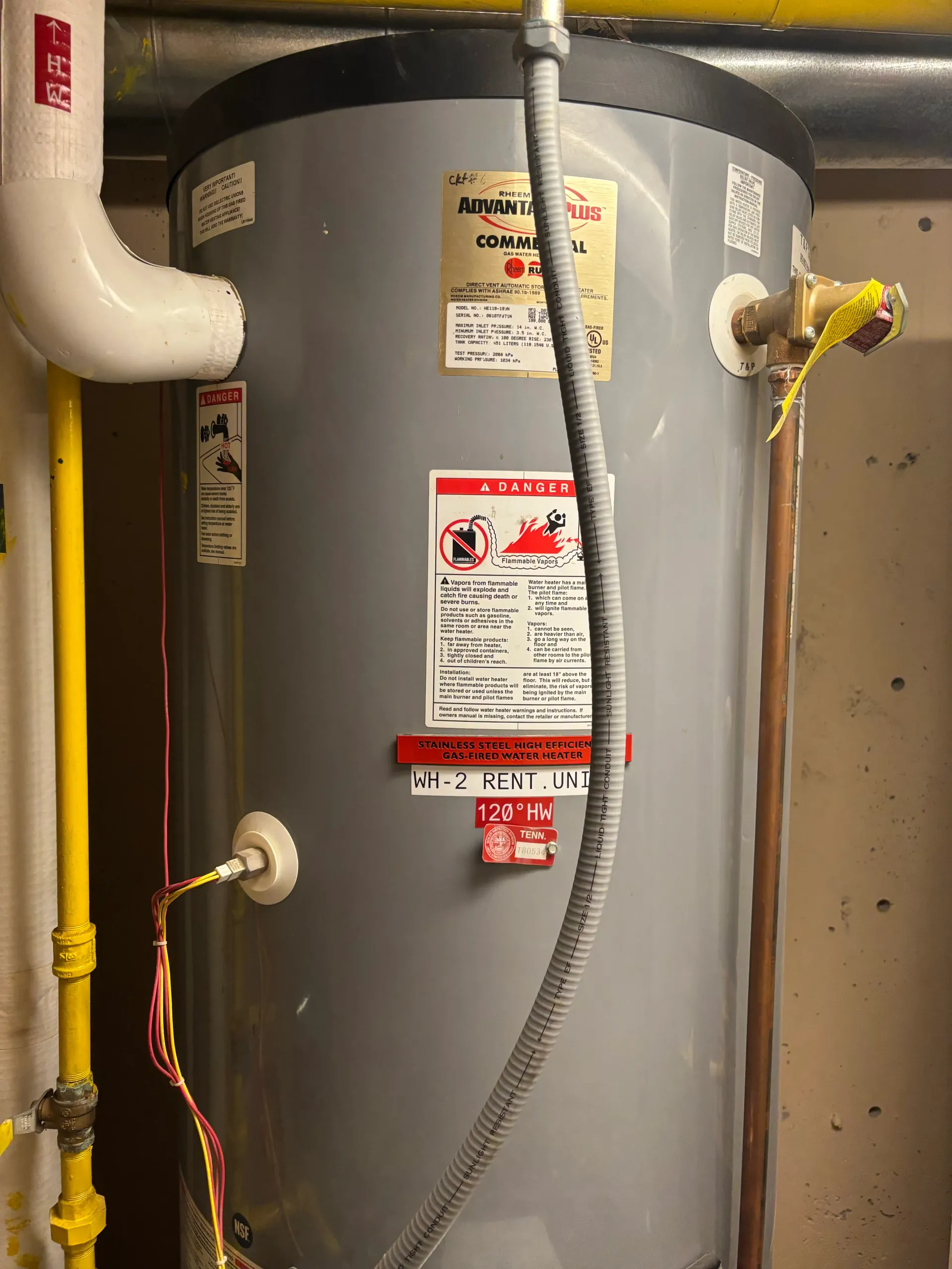Rheem Advantage Plus commercial gas water heater installation with connected gas and water lines